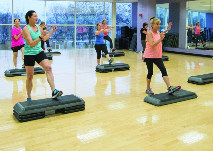 Adults exercising in a fitness class together