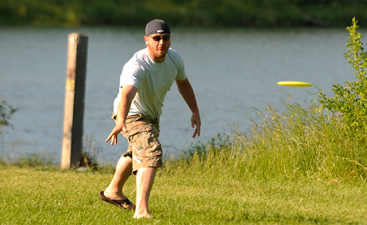 Man throwing Frisbee in park