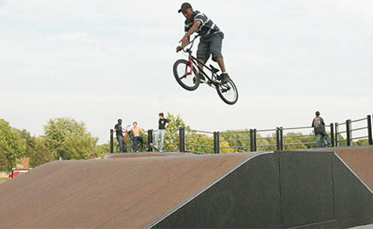 Man jumping over ramp on bicycle
